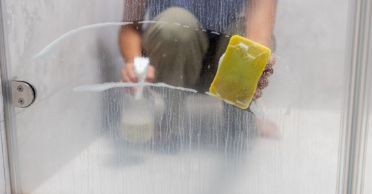 woman cleaning hard water stains